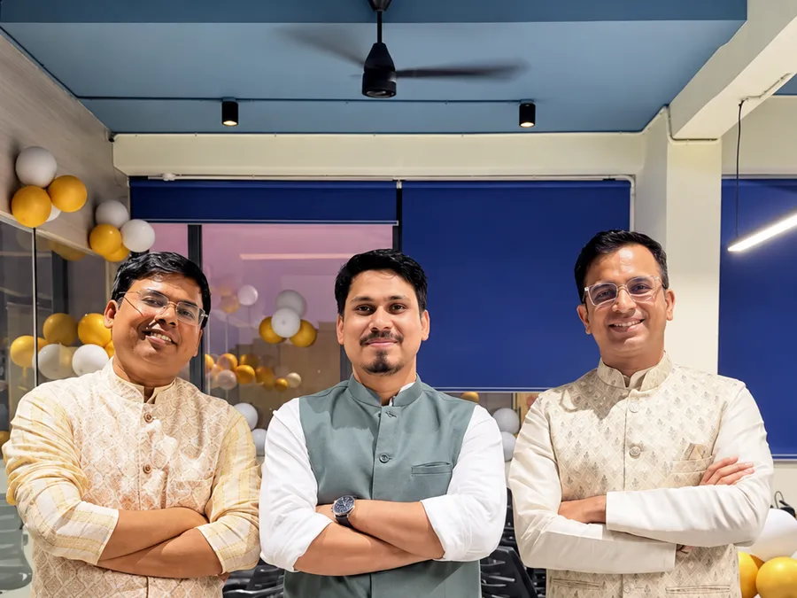 Three Race Digital teammates at an office celebration